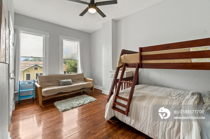 shared kids bedroom with bunk bed, big table and wall shelves, for two boys