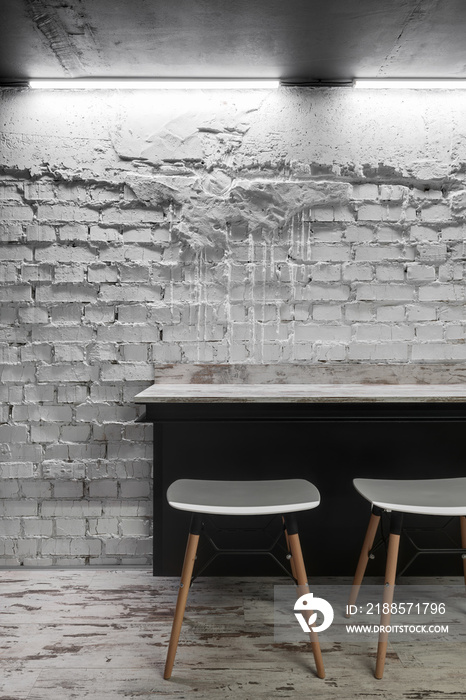 White brick wall with table, interior with white brick wall in loft style