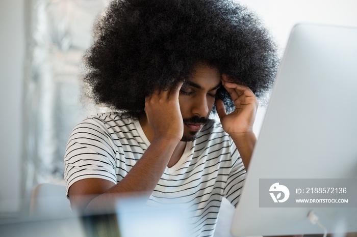 Tired man with eyes closed at office