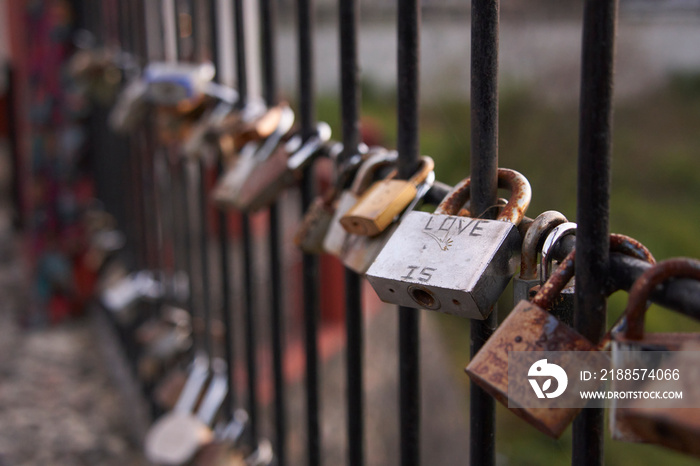 Padlocks attached to a fence to symbolize the love of a couple