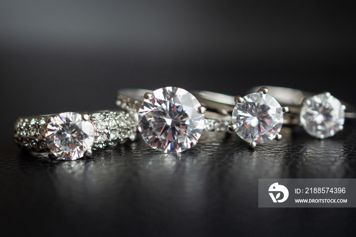 Close up diamond rings jewelry on black leather background