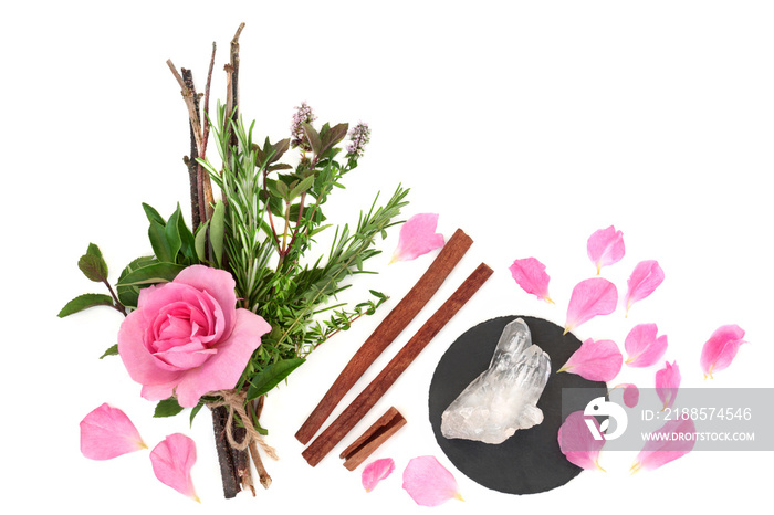 Love potion herbs tied in a witches bundle with pink rose flower, loose petals, cinnamon spice and q