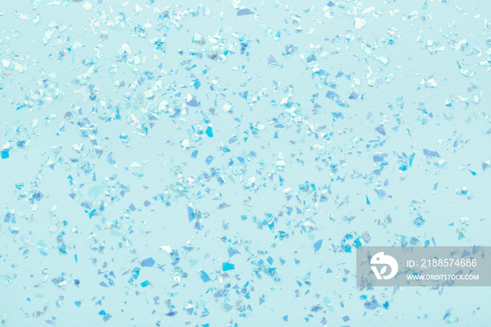 Blue glowing mica glitter on pastel blue trendy abstract background.