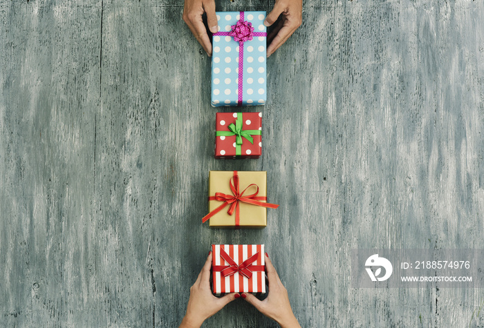 woman and man exchanging gifts