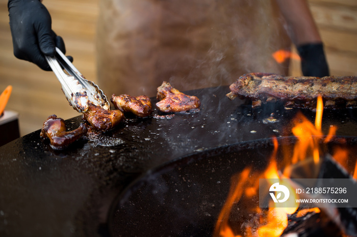 Chicken wings on barbecue grill street food outdoors festival