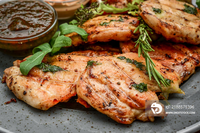 Tasty Grilled chicken fillet and chili peppers on a plate on the table. horizontal view from above