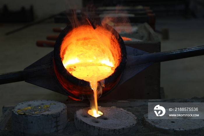 Foundry - molten metal poured from ladle into mould