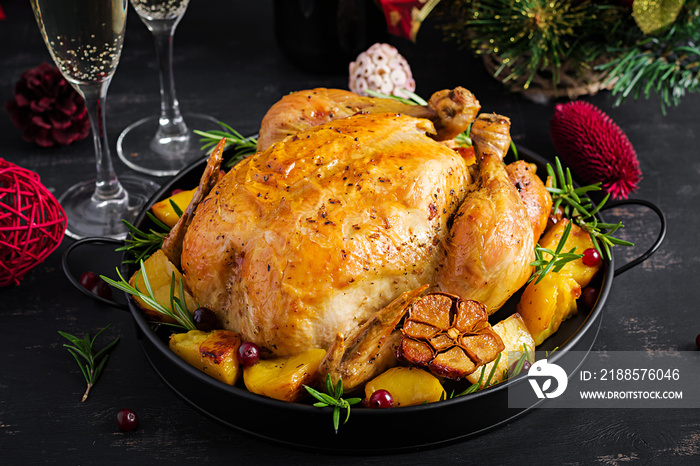 Baked turkey or chicken. The Christmas table is served with a turkey, decorated with bright tinsel. 