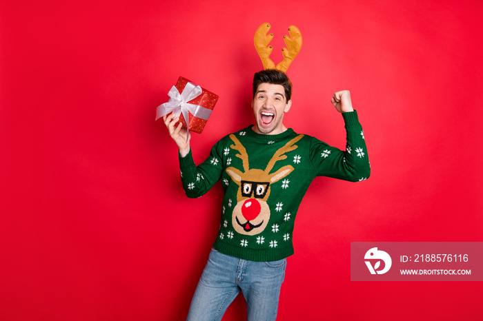 Portrait of his he nice attractive overjoyed cheerful cheery guy wearing deer sweater holding in han