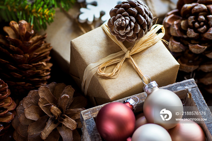 Pile of Christmas and New Year Gift Boxes Wrapped in Craft Paper Colorful Balls Big Pine Cones Green