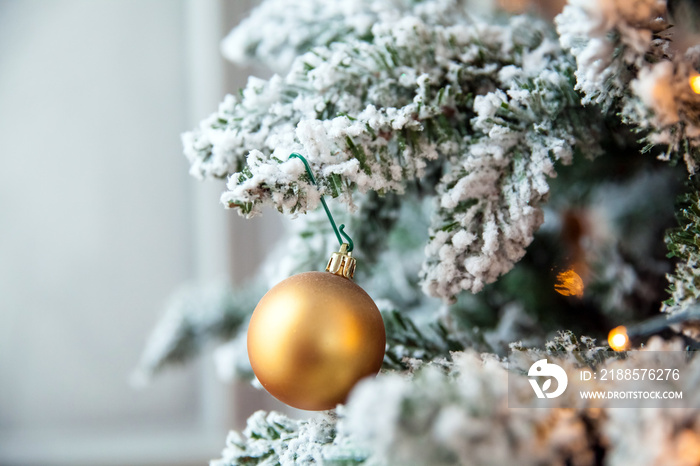 Green New Year tree decorated with balls. Christmas background with lights bokeh effect