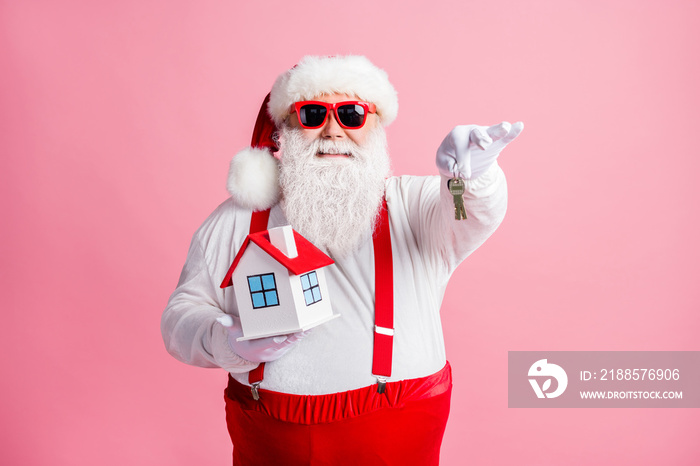 Portrait of his he nice attractive cheerful Santa holding in hands house giving you keys property in