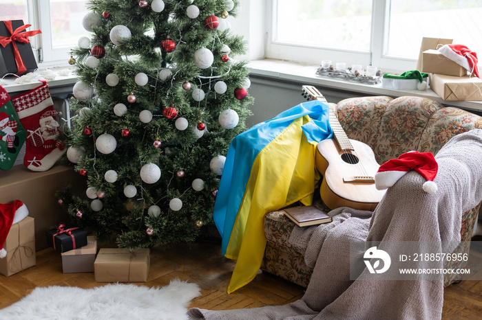 Ukraine flag and gift box on the background of the Christmas tree