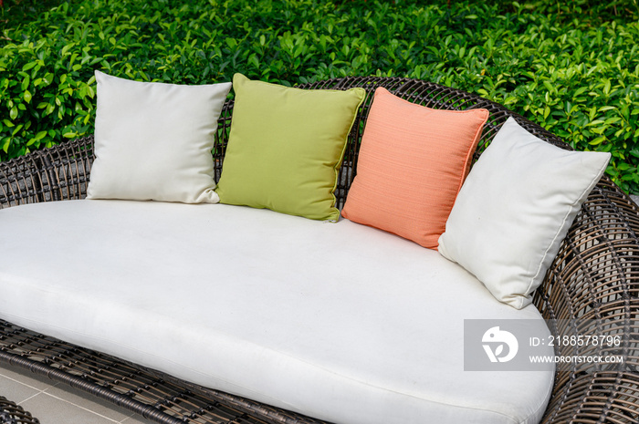 Pillows on mattress and weave wooden sofa