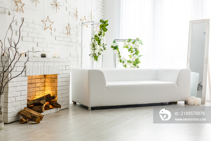 White fireplace in light room with Christmas decoration