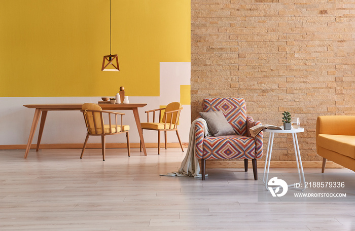 Brick wall and yellow wall room, dining room concept wooden detail and home armchair and sofa.