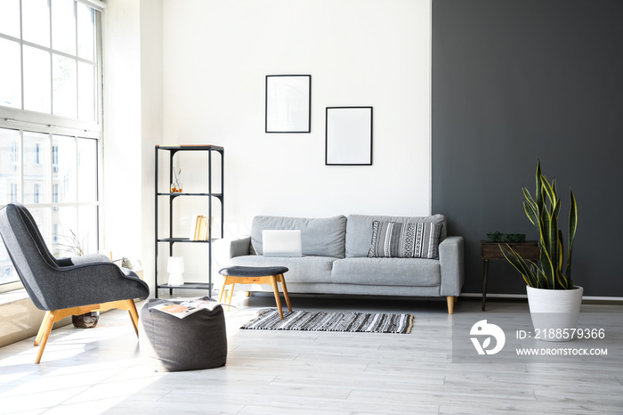 Interior of living room with frames and sofa