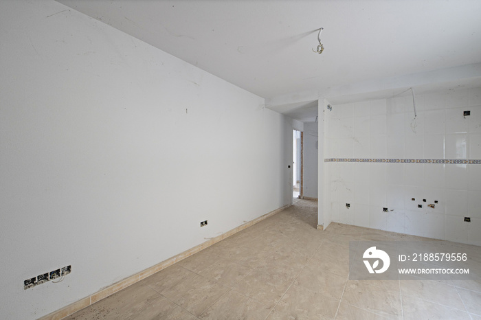 A kitchen room with a tiled wall in need of finishing the electrical auctions