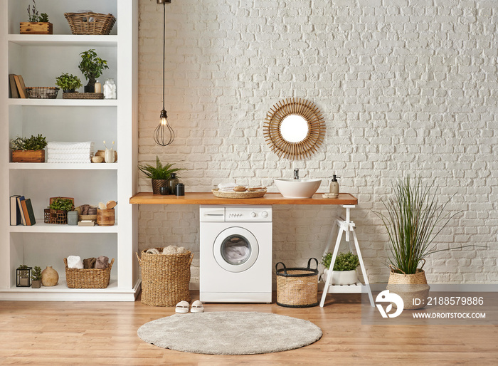 Laundry room interior style, washing machine wicker basket white bookshelf and sink.