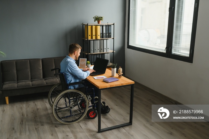 Man in wheelchair at home or in office.