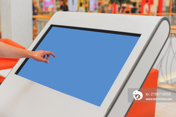 Mockup of digital white screen panel and man’s hand. Blank modern media billboard in the shopping center. Place for text, advertising or public information.