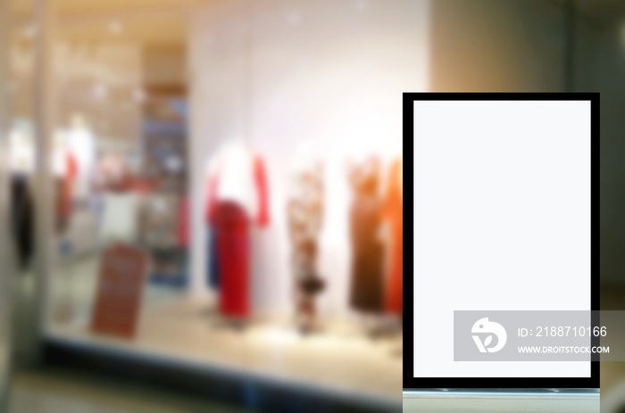 blank advertising light box or showcase billboard for your text message or media content at trendy clothes shop in department store shopping mall, commercial, marketing and advertising concept