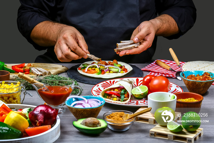 male street vendor hands making taco. Mexican cuisine snacks, cooking fast food for commercial kitchen