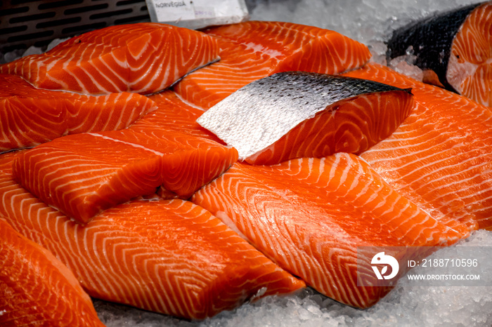 Fresh salmon steaks displayed on the ice in a fish market