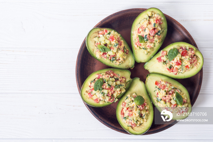 Avocado stuffed with cucumber , tomatoes and eggs