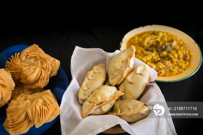 dishes of locro empanadas and sweet pastries, traditional Argentine foods that are frequently consumed for national holidays, such as the revolution of May 25 and independence on July 9