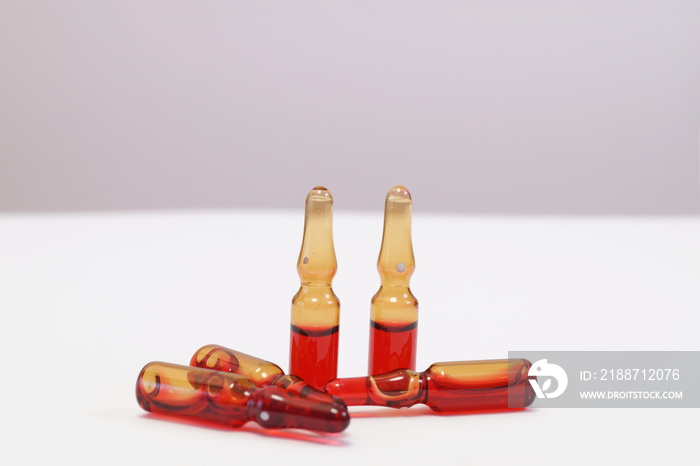 Serum B12 with vitamin C in ampoules for medical treatment. Vitamins concept.