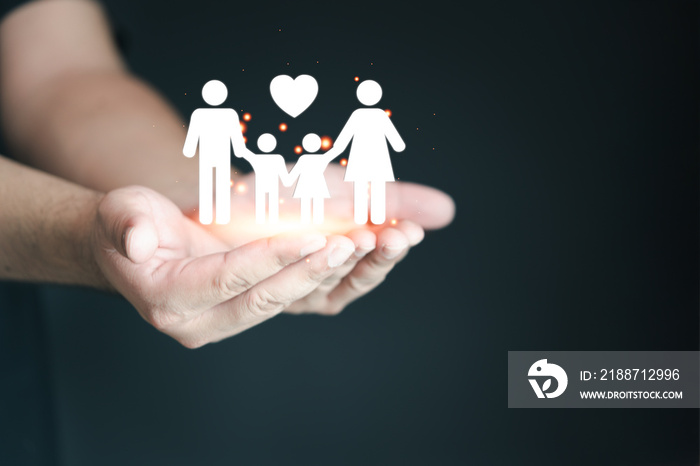 Man hand holding family icon with care and protection, security and health care insurance concept. Father, mother, daughter and son.