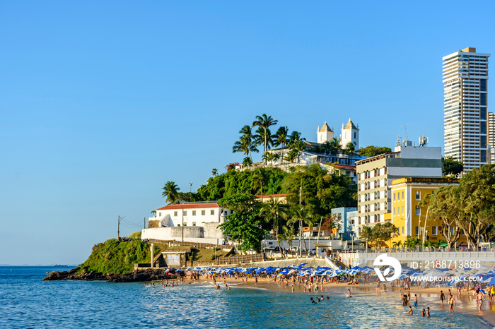 Full beach in sunny day with calm sea in summer of Salvador city in Bahia, Brazil