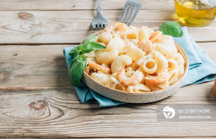 Italian pasta with garlic creamy sauce, shrimp and basil