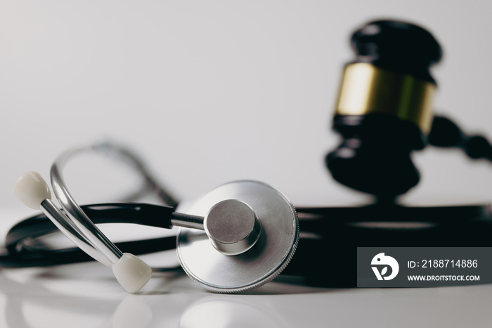 Stethoscope and gavel on white background, symbol of law and medic