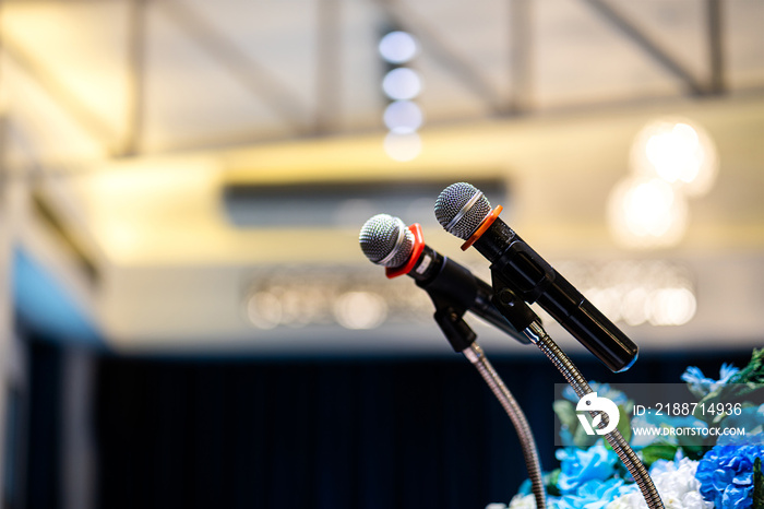 Wireless microphone which is prepared on the stage’s podium, for business president speaking. Photo with blurred background of conventional hall room. Close-up and selective focus at the mic part