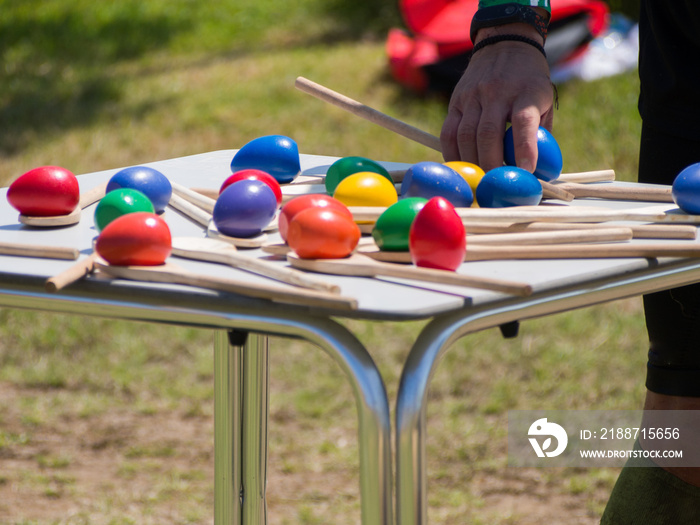 Colorful eggs and wood spoons on a table for balance competition of crossfit