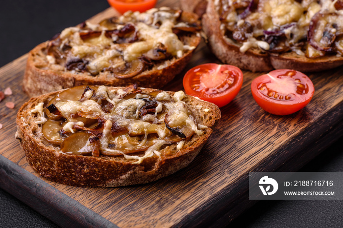 Delicious crispy toast or bruschetta with fried onion, champignon mushrooms and cheese