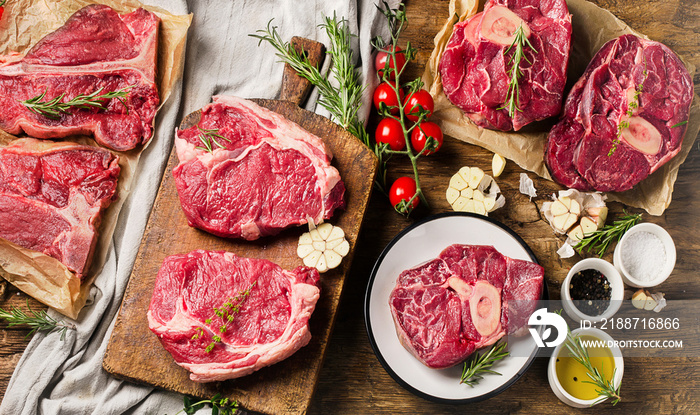 Raw beef meat on a dark wooden board.