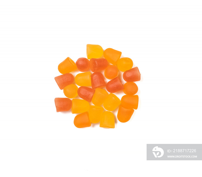 Close-up texture of orange and yellow multivitamin gummies on white background.  Healthy lifestyle concept.