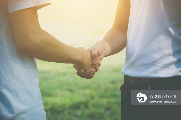 Two men volunteer handshake for congratulate each other