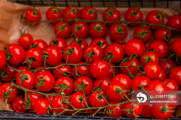 small red tomatoes on the counter of vegetable market, background