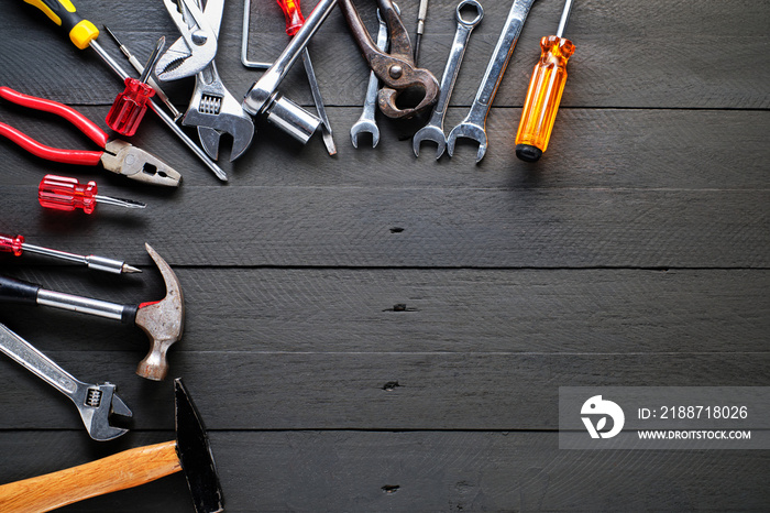 Working tools on black wooden background.