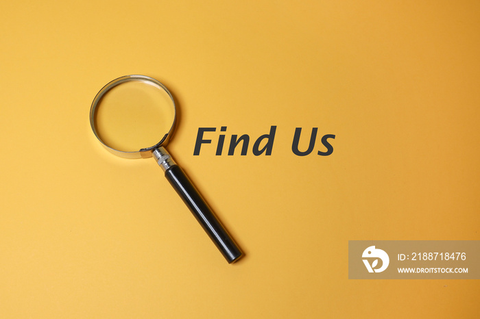 A magnifying glass and text on Find Us on the yellow background