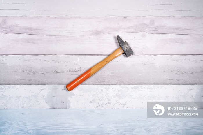 Carpenter’s hammer on a background of old boards. Top view