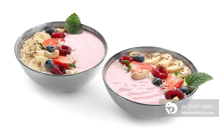 Bowl with pink yogurt and fresh fruits on white background