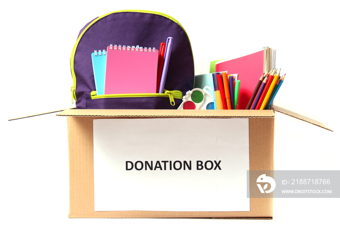 donation box with school stationery items isolated on white