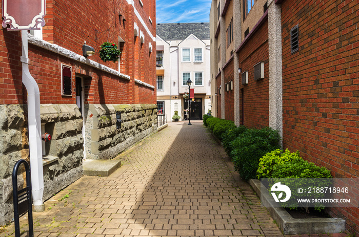 Narrow Alley Between Two Brick Buildings in Duncan, BC, Canada, on a Sunny Summer Day.