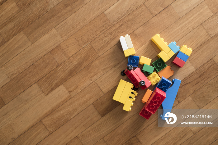 toy bricks on wooden floor. Colorful plastic blocks. childhood education concept