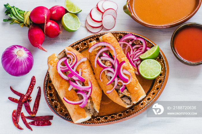 tortas ahogadas, traditional Mexican Food from Jalisco Guadalajara Mexico, spicy sandwich in a red sauce